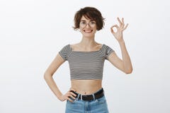 You are right, like your plan. Portrait of confident happy cutie in round glasses and trendy striped cropped top royalty free stock images You are right, like your plan. Portrait of confident happy cutie in round glasses and trendy striped cropped top royalty free stock images