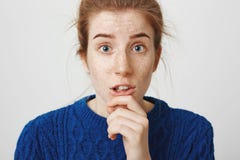 Are you sure she is not mad at me. Worried confused girl with red hair and cute freckles, holding finger on chin and stock photos Are you sure she is not mad at me. Worried confused girl with red hair and cute freckles, holding finger on chin and stock photos