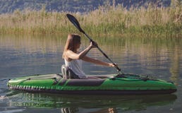 Young woman kayaking on the lake royalty free stock photos Young woman kayaking on the lake royalty free stock photos