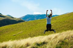 Young adult woman jumping on meadow royalty free stock image Young adult woman jumping on meadow royalty free stock image