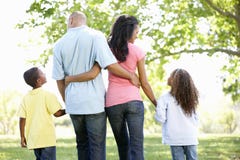 Young African American Family Enjoying Walk In Park Stock Photos Young African American Family Enjoying Walk In Park Stock Photos