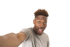 Young afro american man smiling happy taking selfie self portrait picture with mobile phone Royalty Free Stock Images Young afro american man smiling happy taking selfie self portrait picture with mobile phone Royalty Free Stock Images