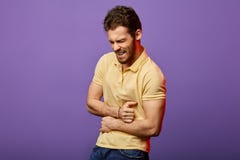 Young angry handsome man suffering from pain in his stomach royalty free stock images Young angry handsome man suffering from pain in his stomach royalty free stock images