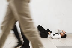 Young asian businessman lying down at walkway thinking of his problem and look so depressed stock photo Young asian businessman lying down at walkway thinking of his problem and look so depressed stock photo