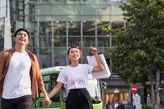 Young Asian couple going out for shopping on Le Loi road in Hochiminh city, Vietnam royalty free stock images Young Asian couple going out for shopping on Le Loi road in Hochiminh city, Vietnam royalty free stock images