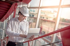 Young Asian Engineer or Architect working with laptop Stock Photography Young Asian Engineer or Architect working with laptop Stock Photography