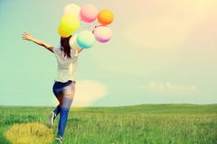 Young asian woman with colored balloons