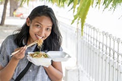 Asian woman eat typical Burmese food on a street Stock Images Asian woman eat typical Burmese food on a street Stock Images
