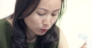 Young Asian woman eating a bowl of noodles at a table in restaurant. stock footage Young Asian woman eating a bowl of noodles at a table in restaurant. stock footage
