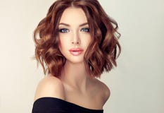 Young and attractive brown haired woman with modern, trendy and elegant hairstyle.