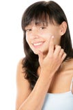 Young attractive brunette woman applying facial skin cream royalty free stock images Young attractive brunette woman applying facial skin cream royalty free stock images