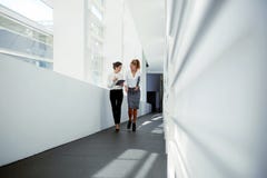 Young attractive female holding touch pad and talking about something cheerful to her partner royalty free stock photos Young attractive female holding touch pad and talking about something cheerful to her partner royalty free stock photos
