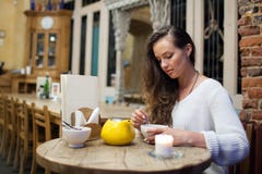 Young attractive girl sitting in the evening in a cafe stock photos Young attractive girl sitting in the evening in a cafe stock photos