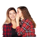 Young attractive girl whispering in the ear of his sister stock image Young attractive girl whispering in the ear of his sister stock image