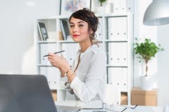Young attractive office worker drinking cup of tea, having coffee break in the morning, getting ready for work day. Royalty Free Stock Photography Young attractive office worker drinking cup of tea, having coffee break in the morning, getting ready for work day. Royalty Free Stock Photography