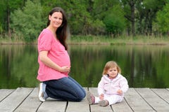 Young Attractive Pregnant Woman With Her Toddler Stock Photography