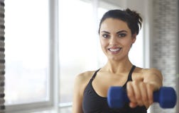 Young sportswoman doing fitness exercises at sport gym stock image Young sportswoman doing fitness exercises at sport gym stock image