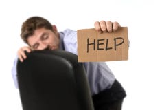 Young attractive tired and wasted businessman sitting on office chair asking for help in stress Stock Image Young attractive tired and wasted businessman sitting on office chair asking for help in stress Stock Image