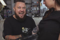 Young attractive woman getting new tattoo by professional tattooist stock images Young attractive woman getting new tattoo by professional tattooist stock images