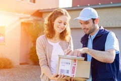 Young attractive woman receiving parcel at home royalty free stock photography Young attractive woman receiving parcel at home royalty free stock photography