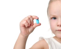 Young baby girl hold light blue headache pill medicine tablet in small hand. Isolated on a white background Royalty Free Stock Photos Young baby girl hold light blue headache pill medicine tablet in small hand. Isolated on a white background Royalty Free Stock Photos