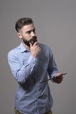 Young bearded concentrated adult business man holding tablet computer thinking and touching beard looking away at copyspace Stock Photos Young bearded concentrated adult business man holding tablet computer thinking and touching beard looking away at copyspace Stock Photos