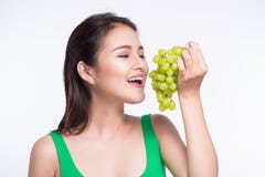 Young beautiful asian woman eating fresh grapes on whit Royalty Free Stock Photo Young beautiful asian woman eating fresh grapes on whit Royalty Free Stock Photo