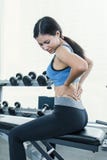 Young beautiful asian woman having pain in her back Stock Photos Young beautiful asian woman having pain in her back Stock Photos