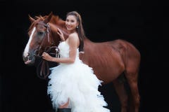 Young beautiful beauty bride in fashion white bridal wedding costume stand by handsome horse on black background royalty free stock image Young beautiful beauty bride in fashion white bridal wedding costume stand by handsome horse on black background royalty free stock image
