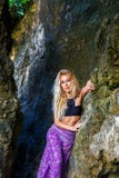 Young beautiful blond girl on the rock of a tropical island. stock image Young beautiful blond girl on the rock of a tropical island. stock image