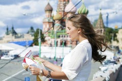 Young Beautiful Girl Holding A Tourist Map Of Moscow, Russia Royalty Free Stock Photos