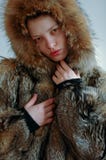 Young beautiful girl shows the photographer part of her young cute body. A wolfskin jacket Stock Photos Young beautiful girl shows the photographer part of her young cute body. A wolfskin jacket Stock Photos
