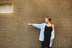 Young beautiful woman against the background of an unusual wooden wall. royalty free stock photography Young beautiful woman against the background of an unusual wooden wall. royalty free stock photography
