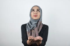 Young beautiful hopeful Muslim woman wearing turban hijab, headscarf holding her hands together looking up isolated royalty free stock images Young beautiful hopeful Muslim woman wearing turban hijab, headscarf holding her hands together looking up isolated royalty free stock images
