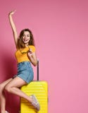 Woman tourist with travel suitcase isolated on summer background royalty free stock photo Woman tourist with travel suitcase isolated on summer background royalty free stock photo