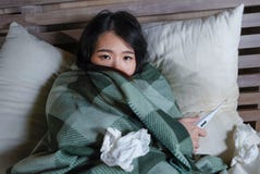 Young Beautiful Sick And Exhausted Asian Chinese Woman Suffering Cold And Flu Holding Thermometer Having Temperature Lying On Bed Royalty Free Stock Photo Young Beautiful Sick And Exhausted Asian Chinese Woman Suffering Cold And Flu Holding Thermometer Having Temperature Lying On Bed Royalty Free Stock Photo