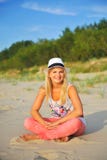 Young Beautiful Summer Woman Sitting On The Beach Royalty Free Stock Image