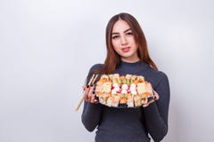 Young beautiful woman with chopsticks and sushi set, studio shoo stock photography Young beautiful woman with chopsticks and sushi set, studio shoo stock photography
