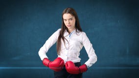 Young beautiful woman dress in white shirt standing in combat pose with red boxing gloves. Business concept. Stock Photography Young beautiful woman dress in white shirt standing in combat pose with red boxing gloves. Business concept. Stock Photography