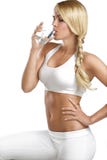 Young beautiful woman drinking a glass of water stock photo Young beautiful woman drinking a glass of water stock photo