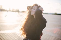 Young beautiful woman with long curly hair dancing and enjoying sunlight stock images Young beautiful woman with long curly hair dancing and enjoying sunlight stock images