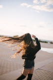 Young beautiful woman with long curly hair dancing and enjoying sunlight royalty free stock photography Young beautiful woman with long curly hair dancing and enjoying sunlight royalty free stock photography