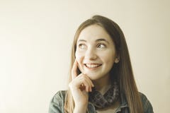 Young beautiful woman smiling and thinking over grey background. stock images Young beautiful woman smiling and thinking over grey background. stock images