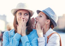 Young Beautiful Woman Telling Secret To Her Friend In The City Royalty Free Stock Images Young Beautiful Woman Telling Secret To Her Friend In The City Royalty Free Stock Images