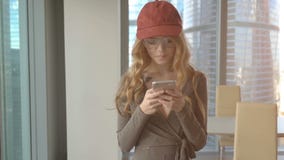Young Beautiful Woman Texting On Smartphone At Her Apartment Stock Photography