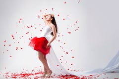 Young Beautiful Woman With Petals Of Roses Stock Photography