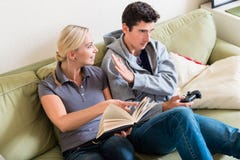 https://thumbs.dreamstime.com/t/young-beautiful-women-smiling-reading-book-next-to-her-boyfriend-watching-tv-sofa-home-young-woman-reading-101059613.jpg