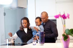 Young Black Family In Fresh Modern Kitchen Royalty Free Stock Photography Young Black Family In Fresh Modern Kitchen Royalty Free Stock Photography