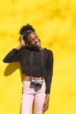 Young black woman in casual clothes with camera royalty free stock image Young black woman in casual clothes with camera royalty free stock image