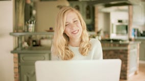 Serious blond woman typing on her laptop stock video footage Serious blond woman typing on her laptop stock video footage